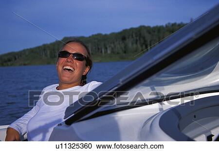 Woman laughing on front of speedboat View Large Photo Image Stock Image - Woman laughing on front of speedboat. Fotosearch