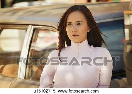 Woman leaning against car View Large Photo Image Stock Photography - Woman leaning against car. Fotosearch