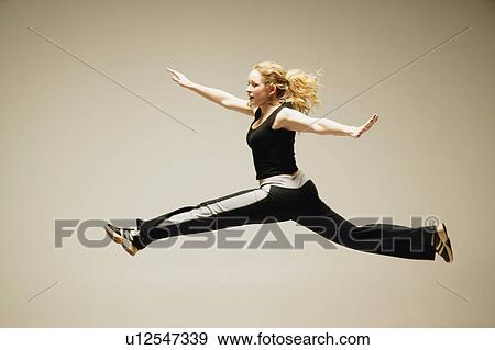 Woman leaps in the air View Large Photo Image Stock Photo - Woman leaps in the air. Fotosearch