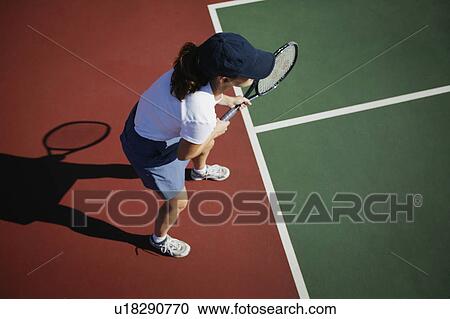 Stock Image - Woman plays tennis. Fotosearch