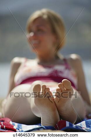 Woman relaxes on the beach View Large Photo Image Stock Photo - Woman relaxes on the beach. Fotosearch