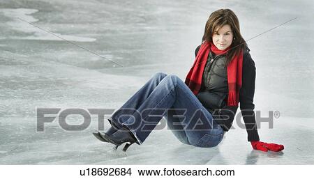 Woman sits on ice View Large Photo Image Picture - Woman sits on ice. Fotosearch