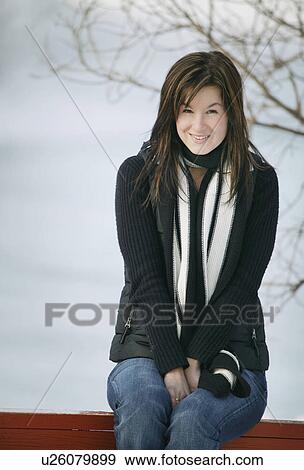 Stock Photo - Woman sits outside. Fotosearch