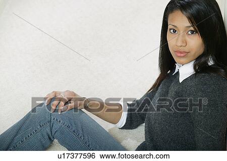 Stock Photograph - Woman sitting down. Fotosearch