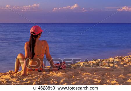 Woman sitting on beach View Large Photo Image Stock Image - Woman sitting on beach. Fotosearch