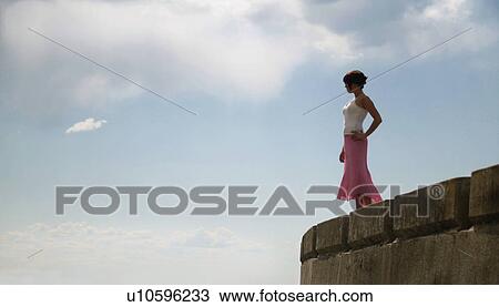 Woman stands on the edge View Large Photo Image Stock Image - Woman stands on the edge. Fotosearch