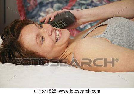 Woman talking on phone View Large Photo Image Stock Photo - Woman talking on phone. Fotosearch