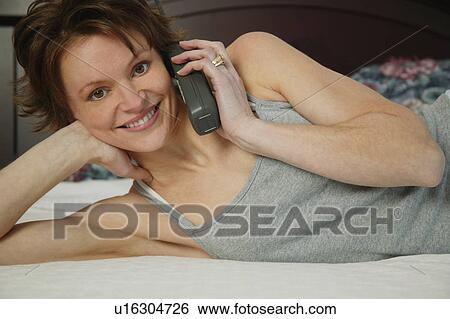 Stock Photograph - Woman talking on phone. Fotosearch