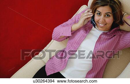 Woman talks on cell phone View Large Photo Image Picture - Woman talks on cell phone. Fotosearch