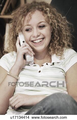 Woman talks on phone View Large Photo Image Picture - Woman talks on phone. Fotosearch