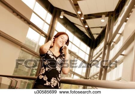 Stock Photo - Woman talks on the phone. Fotosearch