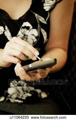 Woman using a PDA View Large Photo Image Stock Image - Woman using a PDA. Fotosearch