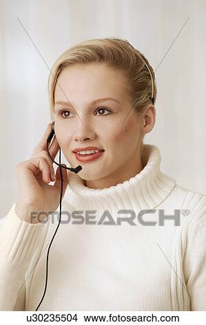 Picture - Woman wearing telephone headset. Fotosearch