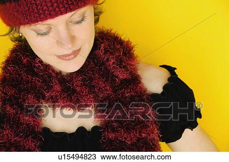 Stock Image - Woman wearing winter hat and scarf. Fotosearch
