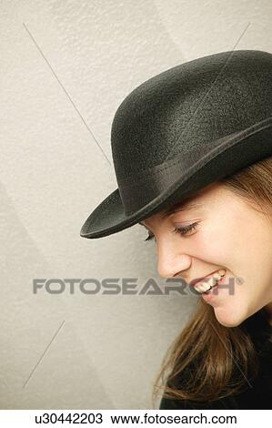Stock Image - Woman with black hat. Fotosearch