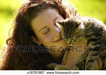 Stock Photo - Woman with her cat. Fotosearch
