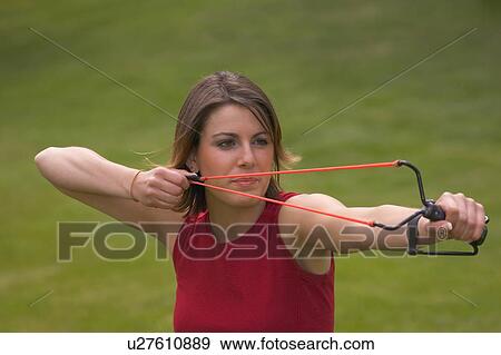 Woman with slingshot View Large Photo Image Stock Photo - Woman with slingshot. Fotosearch