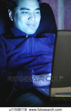 Working late on lap top View Large Photo Image Stock Photo - Working late on lap top. Fotosearch