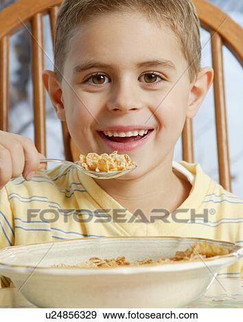 Young boy eating cereal View Large Photo Image Stock Photo - Young boy eating cereal. Fotosearch