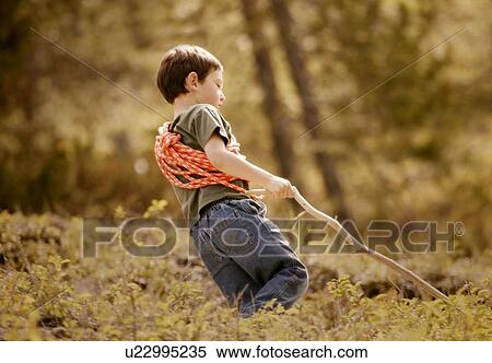 Young boy walking through woodland View Large Photo Image Stock Photography - Young boy walking through woodland. Fotosearch