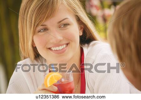Stock Photograph - Young female with drink. Fotosearch