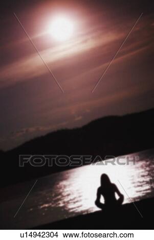 Picture - young woman by lake. Fotosearch