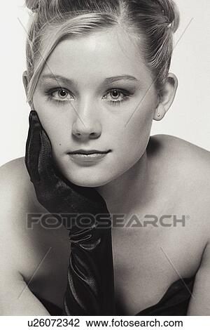 Stock Image - Young woman with black glove. Fotosearch