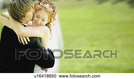 Stock Image - A hug and kiss. Fotosearch