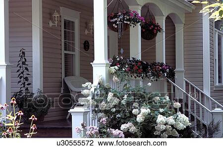 A veranda of a house with a garden in the foreground View Large Photo Image Stock Image - A veranda of a house with a garden in the foreground. Fotosearch