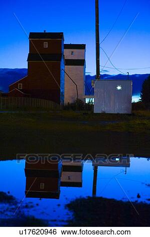 Stock Photograph - Grain elevators at night. Fotosearch