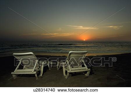 Lounge chairs on a beach View Large Photo Image Stock Image - Lounge chairs on a beach. Fotosearch