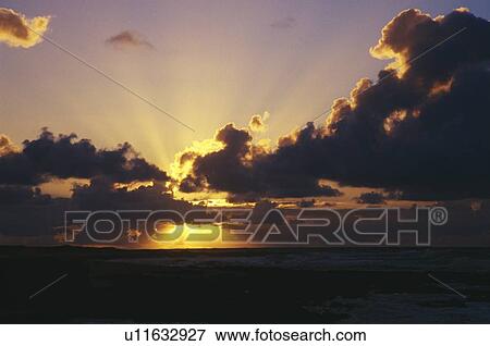 Sunrise through dark clouds, Sand Beach Park View Large Photo Image Stock Photo - Sunrise through dark clouds, Sand Beach Park. Fotosearch