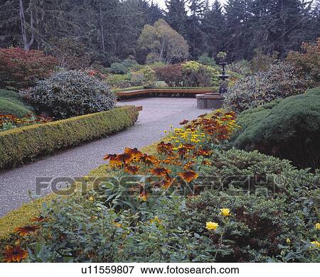 Stock Photo - Plaza filled with flowers and shrubs. Fotosearch