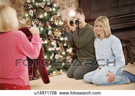 Stock Photo - A family on Christmas morning. Fotosearch