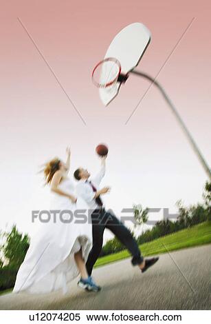 Bride and groom play basketball View Large Photo Image Stock Photography - Bride and groom play basketball. Fotosearch