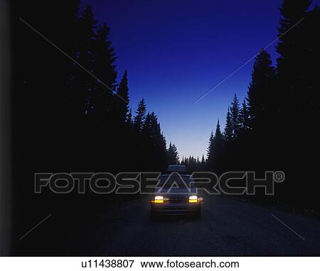 Cars on remote forest road at twilight View Large Photo Image Stock Photo - Cars on remote forest road at twilight. Fotosearch