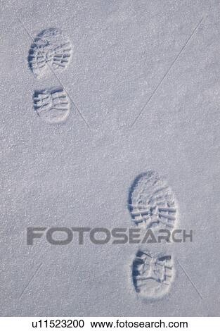 Stock Image - Foot prints in the snow. Fotosearch