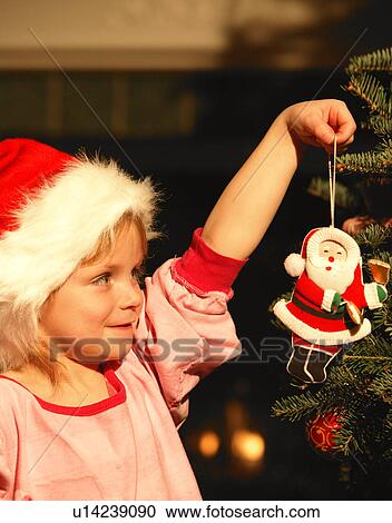 Girl Hanging Ornament on Christmas Tree View Large Photo Image Stock Image - Girl Hanging Ornament on Christmas Tree. Fotosearch