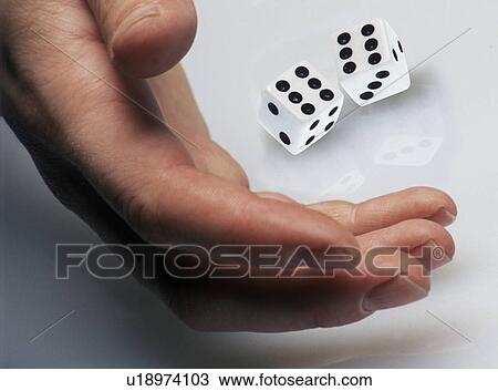 Hand rolling dice on white surface View Large Photo Image Stock Image - Hand rolling dice on white surface. Fotosearch