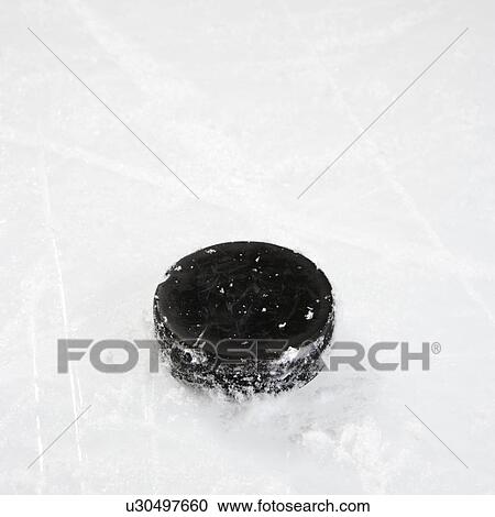 Black hockey puck on ice rink. View Large Photo Image Stock Image - Black hockey puck on ice rink.. Fotosearch