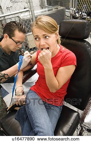 Caucasian male tattoo artist tattooing Caucasian woman. View Large Photo Image Stock Image - Caucasian male tattoo artist tattooing Caucasian woman.. Fotosearch