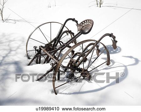 Classic metal plow sitting in snow covered field. View Large Photo Image Stock Image - Classic metal plow sitting in snow covered field.. Fotosearch