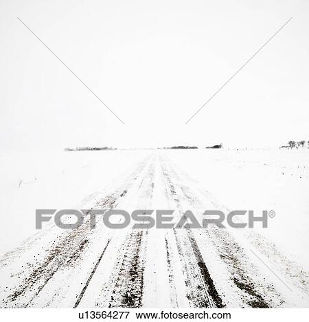 Stock Photo - Deserted dirt road in blizzard.. Fotosearch