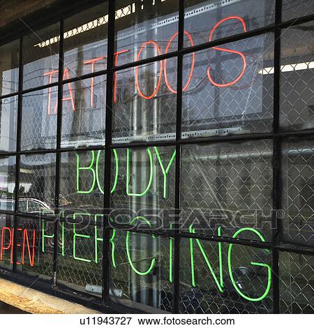 Neon sign in window for tattoos and body piercing. View Large Photo Image Stock Photo - Neon sign in window for tattoos and body piercing.. Fotosearch