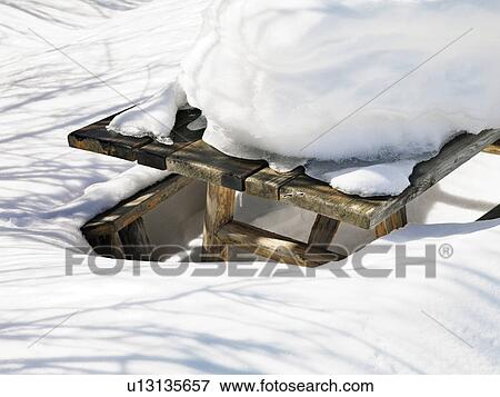 Picnic table covered in snow. View Large Photo Image Stock Photo - Picnic table covered in snow.. Fotosearch