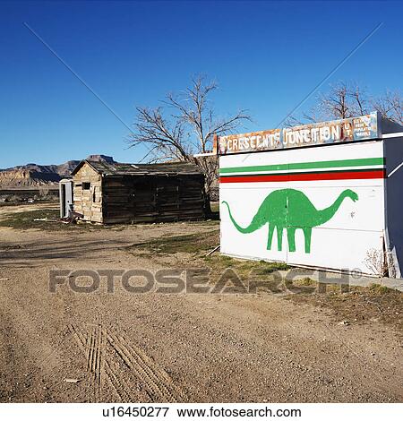 Stock Photo - Small building iwht dinosaur painted on side in Crescent Junction, Utah. . Fotosearch