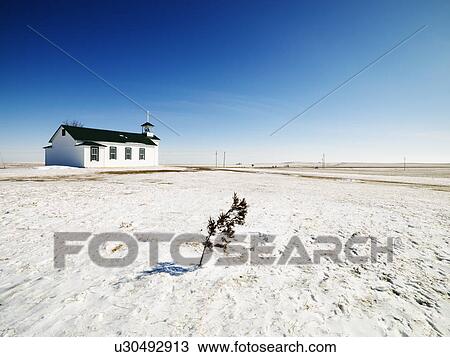 Stock Image - Small white church with tree in foreground.. Fotosearch