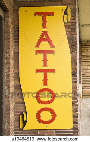Stock Photo - Tattoo sign outside of tattoo parlor.. Fotosearch