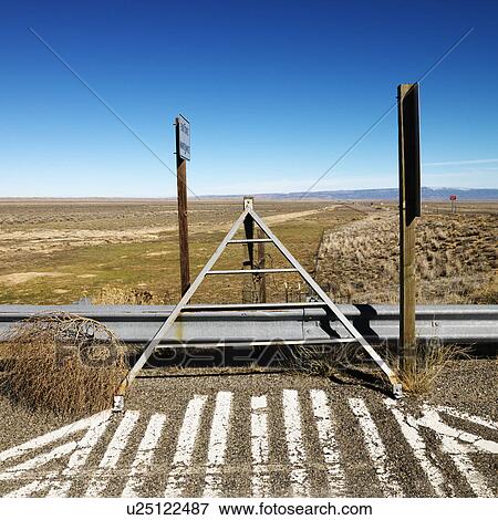 Tumbleweed beside guardrail with blue sky in background. View Large Photo Image Stock Photo - Tumbleweed beside guardrail with blue sky in background.. Fotosearch
