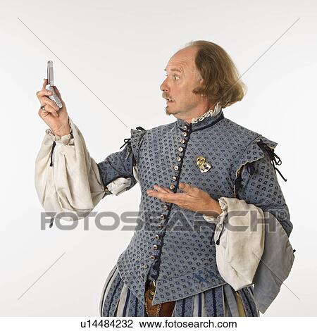 William Shakespeare in period clothing looking at cell phone with astonishment. View Large Photo Image Stock Image - William Shakespeare in period clothing looking at cell phone with astonishment.. Fotosearch